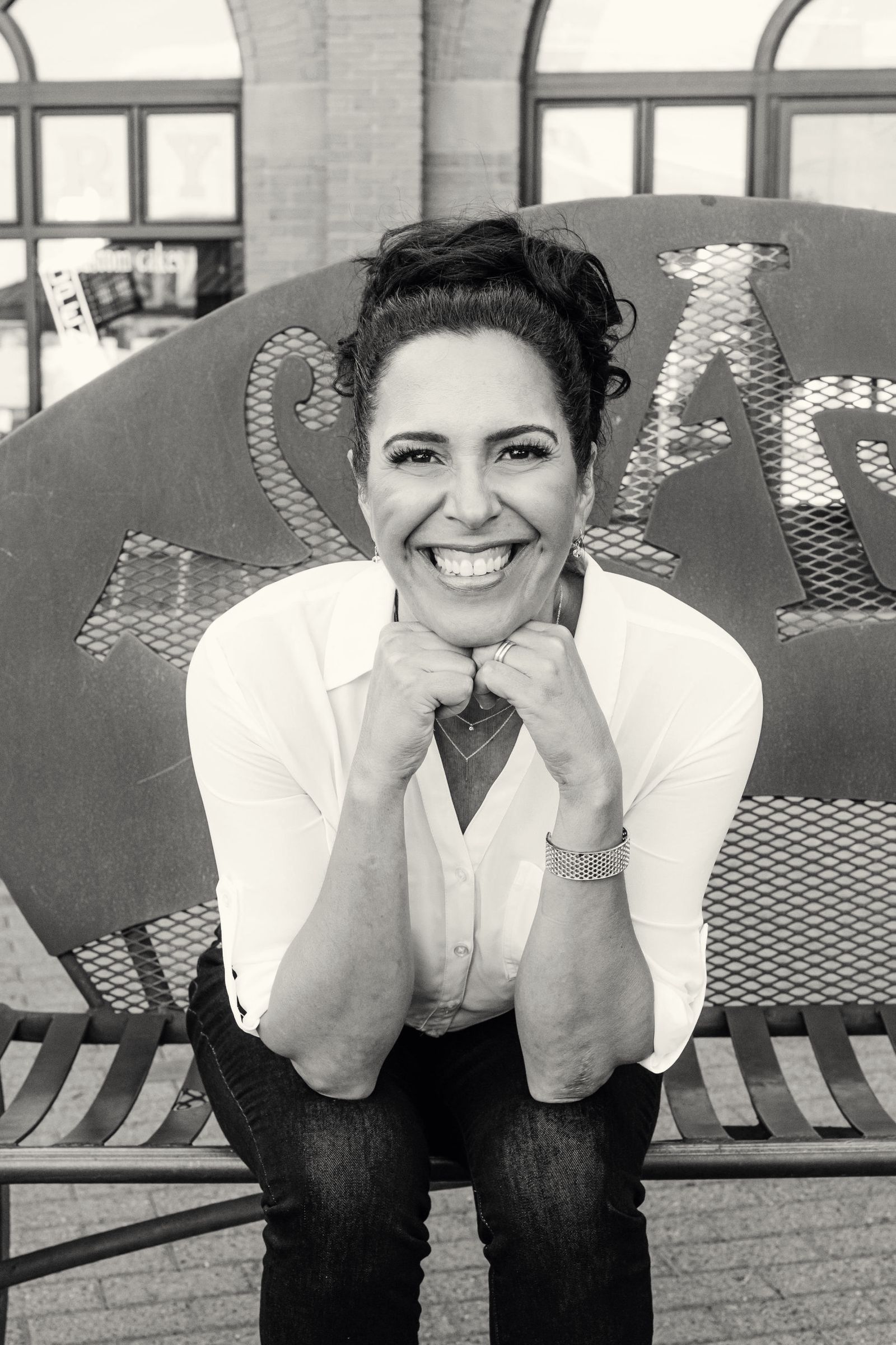 Lisa Lopez, chin resting on her hands, smiling