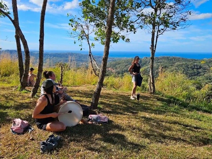 A drum played softly on a hilltop above the forest