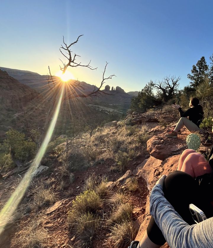 Women watching the sun rise over Sedona red rock